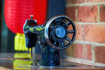 Close-up of a vintage Chinese tailor with a sewing machine