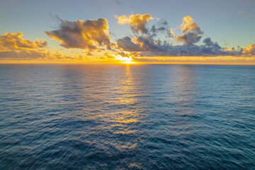 Aerial sunrise over the sea with clouds
