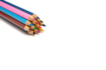 Bright colored pencils on a white background.School supplies for drawing.