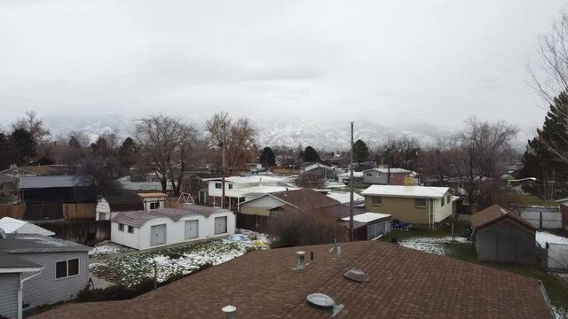 Drone shot flying over a suburban home in winter time, Layton town, Utah