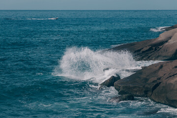 The waves of the Atlantic Ocean crash on rocks with splashes in Tenerife