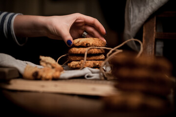 Hand holding a crunchy homemade almond cookies. Selective focus.