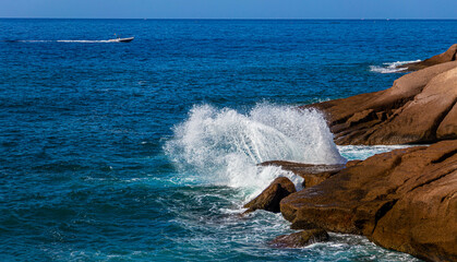 The waves of the Atlantic Ocean crash on rocks with splashes in Tenerife