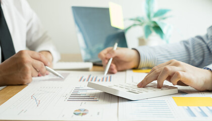 Two business leaders talk about charts, financial graphs showing results are analyzing and calculating planning strategies, business success building processes
