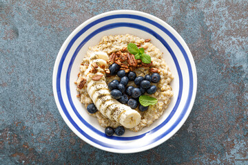 Oatmeal with fresh blueberries and pecans and banana