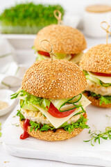 Hamburger with grilled chicken burger, fresh cucumber, tomato, cheese and lettuce.