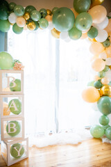 baby shower decorations with green and gold balloons