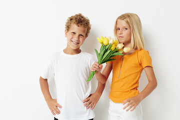 Fototapeta na wymiar two joyful children fun birthday gift surprise bouquet of flowers isolated background unaltered