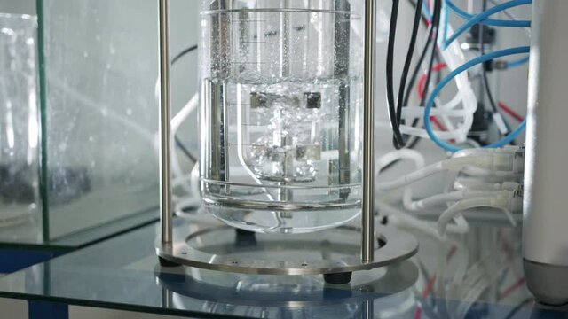 Slow motion shot of a mixer used in a chemistry lab to mix liquids