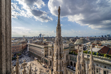 Milan, Italy. Panoramic aerial view from Duomo Cathedral terraces, terrazze del Duomo, with a dramatic sky.