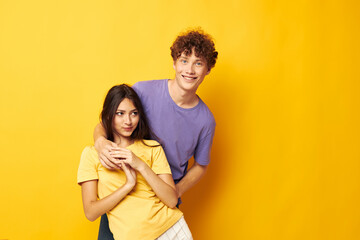 Naklejka premium young boy and girl Friendship posing fun studio yellow background unaltered