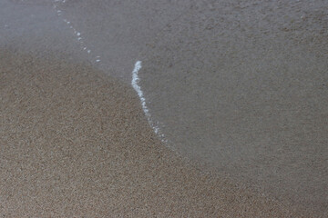 Wet coastal sand.