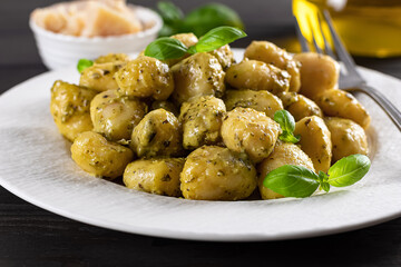 Gnocchi with pesto sauce and parmesan.