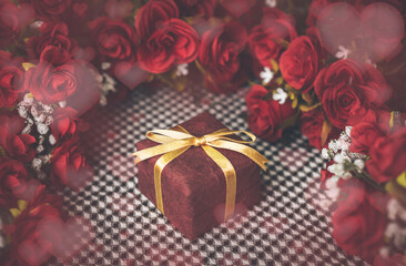 Beautiful red valentine present box with rose flower on background and heart bokeh. 14 February.  craft paper present box for birthday. Christmas presents. Valentine's day concept. Chinese new years.
