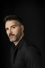 Fototapeta premium Portrait of a handsome man with beard on black background