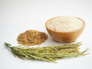 White rice (Jasmine rice) in wooden bowl and unmilled rice on white background.  closeup photo, blurred.