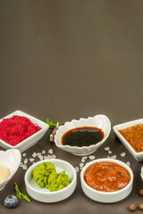 Set of different sauces - ketchup, mayonnaise, barbecue, soy, chutney, wasabi, adjika, horseradish
