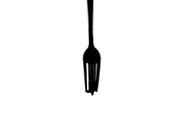 plastic fork in black paint on a light background