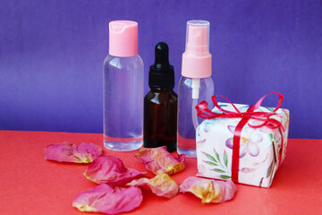 A set of cosmetics as a gift with rose petals