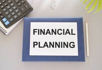 FINANCIAL PLANNING text written on white paper above on Notebook. business concept,Top view flat lay.
