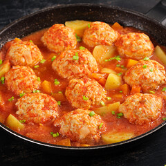 Meatballs with pumpkin and potato slices in tomato sauce. Diet food. Healthy food