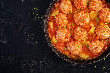 Meatballs with pumpkin and potato slices in tomato sauce. Diet food. Healthy food. Top view, above