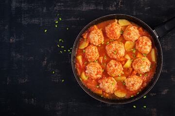Meatballs with pumpkin and potato slices in tomato sauce. Diet food. Healthy food. Top view, above