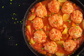 Meatballs with pumpkin and potato slices in tomato sauce. Diet food. Healthy food. Top view, above
