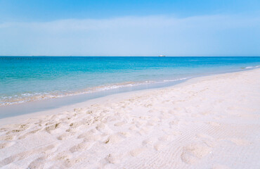A beautiful beach with white sand and turquoise waters.