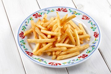 golden french fries on the wooden background
