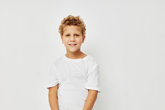 Photo of young boy smile in white t-shirt isolated background