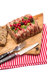 Traditional French terrine covered with bacon isolated on wooden cutting or serving board