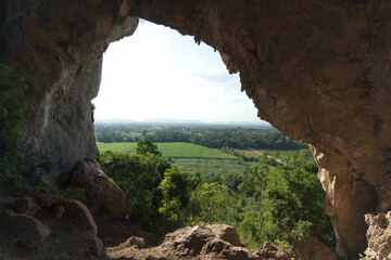 Mountain view through the hole in the cave