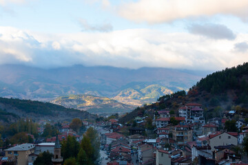 Fototapeta premium Historical old white small wooden houses of Mudurnu among mountains and trees.