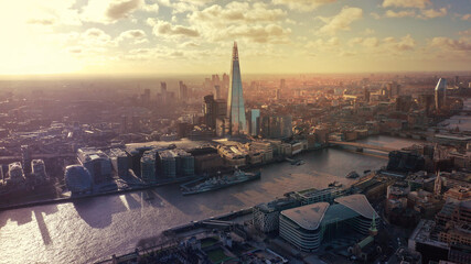 Aerial drone photo of Tower bridge and famous the Shard skyscraper in financial area of City of London as seen at sunset, United Kingdom