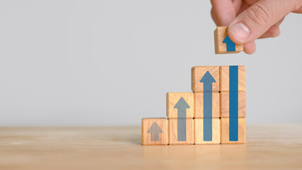 Ladder career path for business growth success process concept.Hand arranging wood block stacking as step stair with arrow up