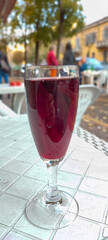 a glass of wine is on the table in a cafe