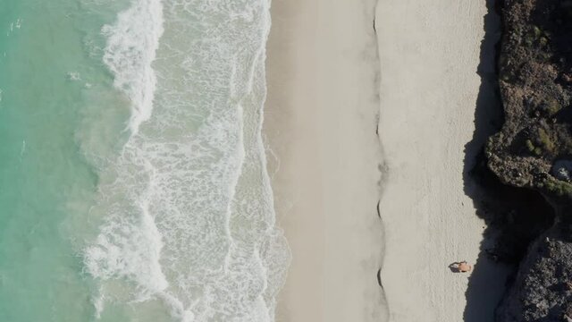 Top-down of Sunbather laying on Tecolote Beach, Baja, Mexico