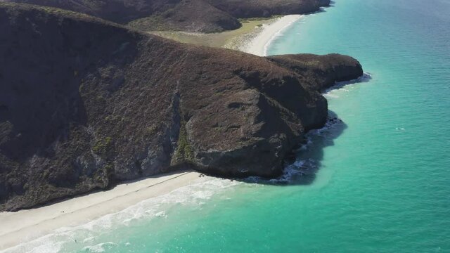 Drone rotates over the Tecolote Beach cliffs in Baja, Mexico