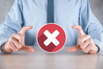 Hand holds icon,cancellation symbol,cancel icon.Cross mark flat red icon.round X mark.cancel button.Wrong.cross mark rejection.Declined.On dark background.Banner.Copy space.Place for text.