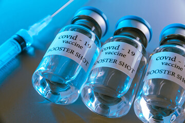 COVID-19 booster vaccine vials. Medicine and health care concept