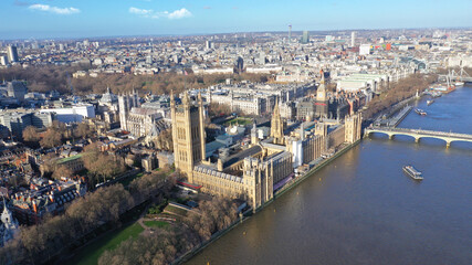 Fototapeta na wymiar Aerial drone photo of iconic City of Westminster with houses of Parliament, Big Ben and Westminster Abbey in front of river Thames at sunset, London, United Kingdom