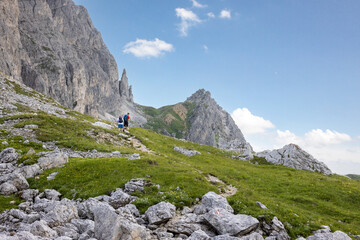 People hiking on a mountain slope in the Dolomites
