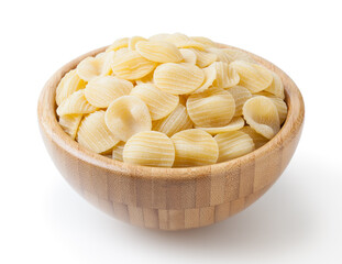 Uncooked orecchiette pasta in wooden bowl isolated on white background with clipping path