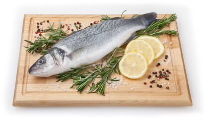 Fresh uncooked sea bass with lemon and rosemary on wooden board over white backdground with clipping path