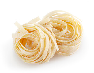 Uncooked tagliatelle pasta isolated on white background with clipping path