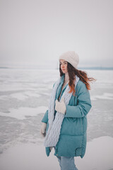 a beautiful girl walks on a frozen lake