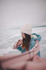 a beautiful girl walks on a frozen lake