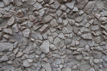 light gray gravel pebble dash on the wall (front view)