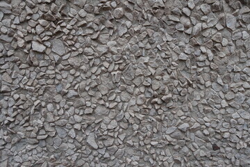 Wall with light gray gravel pebble dash (front view)